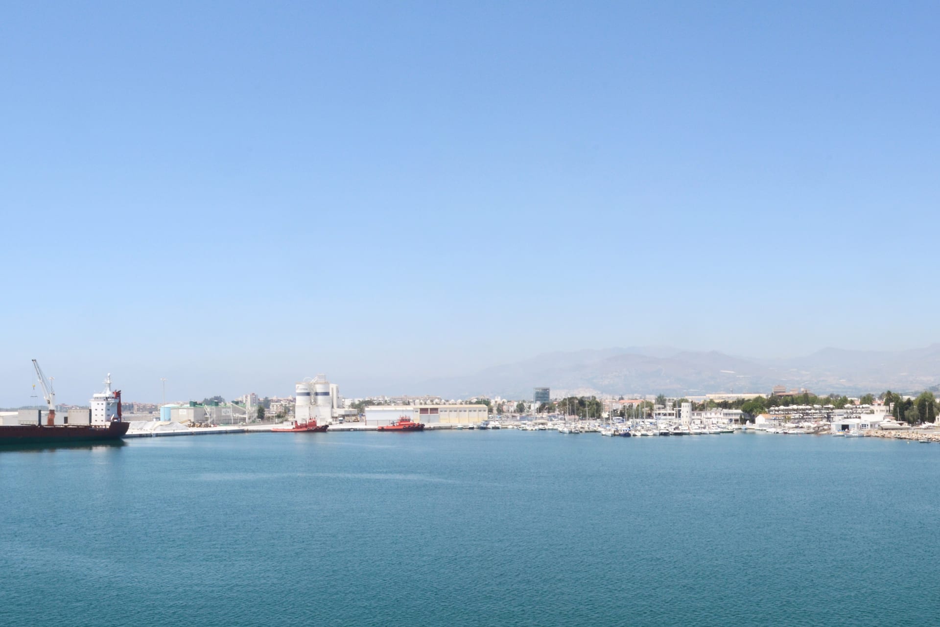 Working Port of Motril with commercial quay, marina, city and Sierra de Lújar beyond