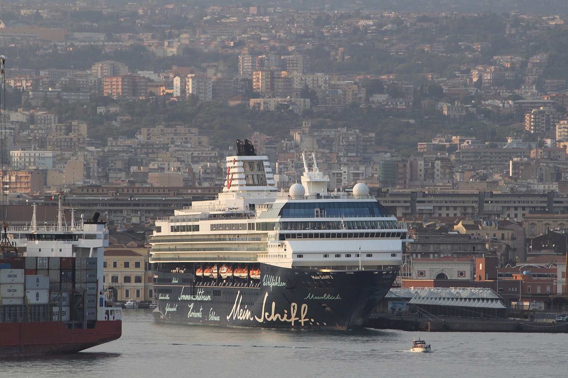 Cruise ship Mein Schiff 2 berthed in the Port of Catania with the Sicilian city behind