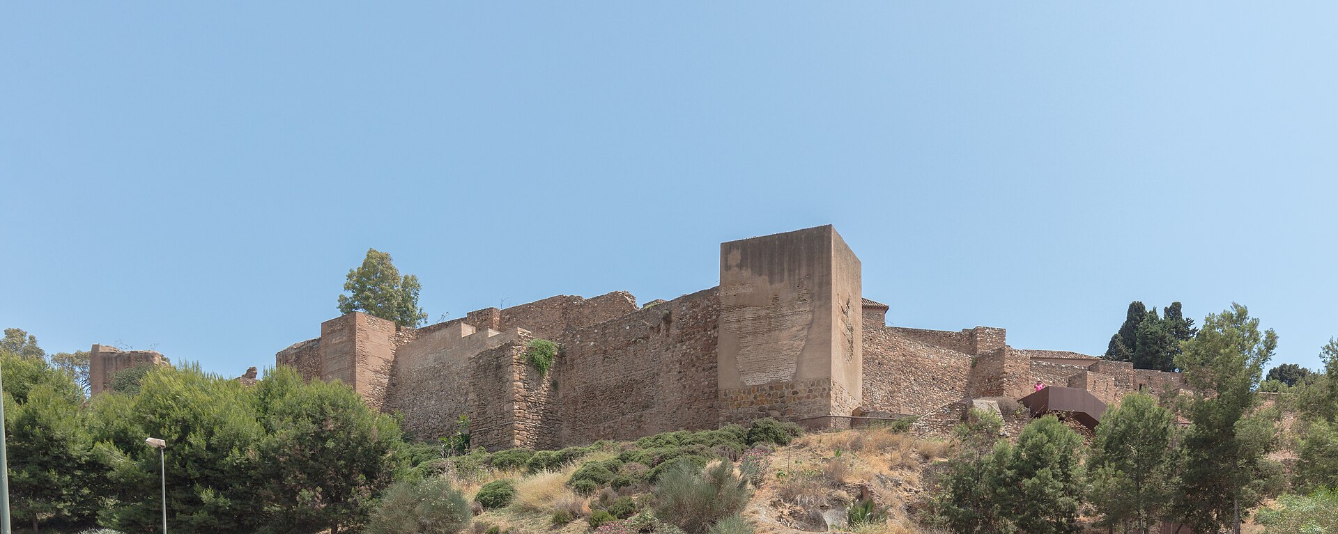 Long stone walls and towers of the Alcazaba rising above Málaga
