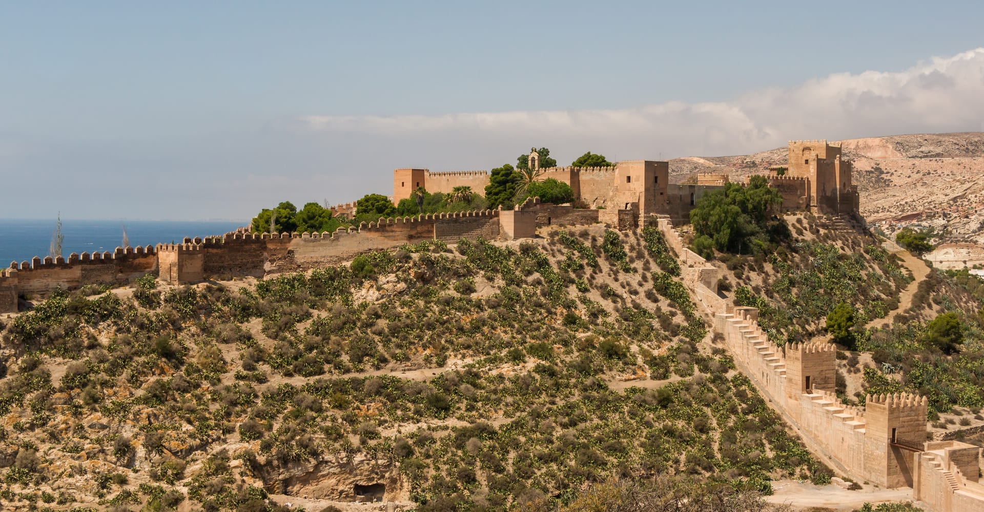 The Alcazaba of Almería stretching across a sunlit hill above the Mediterranean