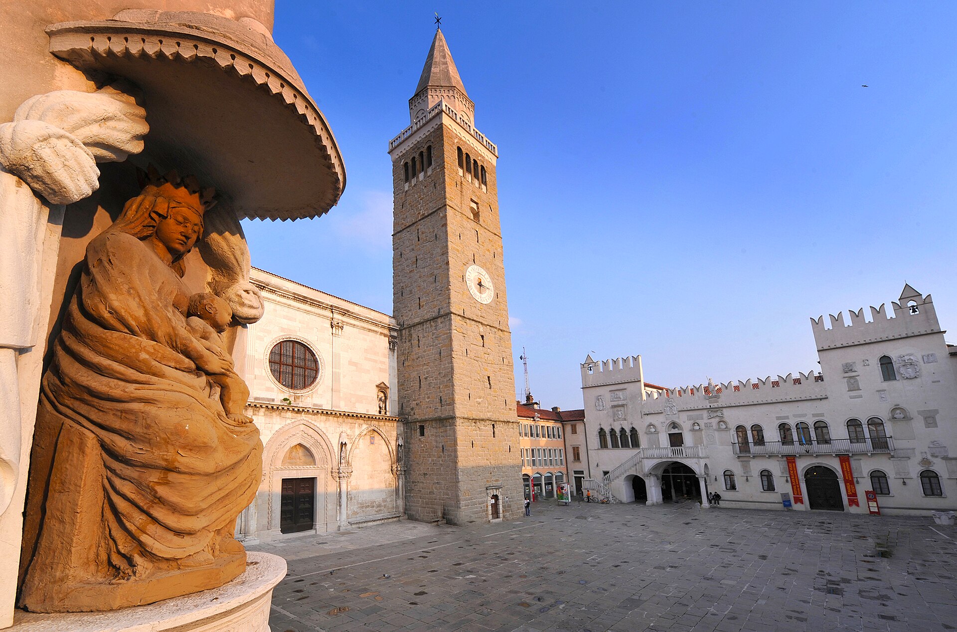 Koper Cathedral bell tower and Praetorian Palace across Tito Square