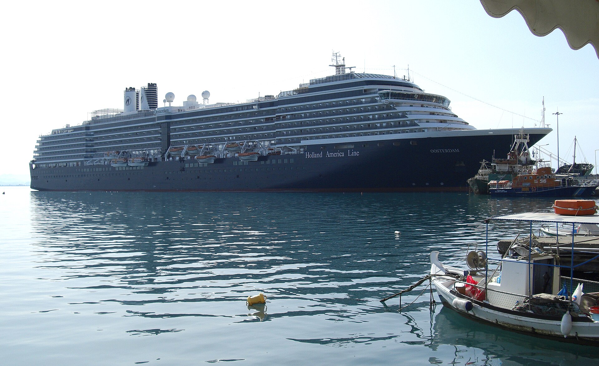 Cruise ship berthed in Katakolon's harbor beside small local boats