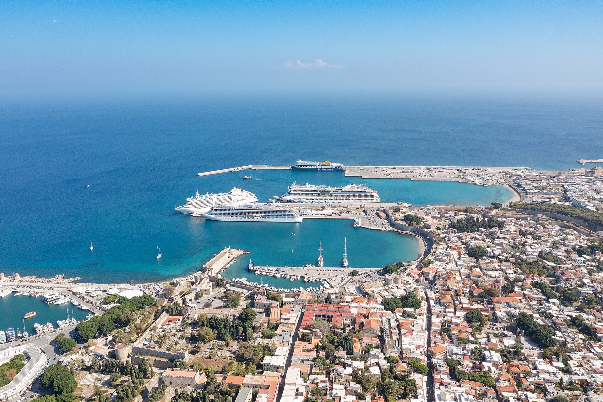 Aerial view of Rhodes Tourist Harbor beside the walled Old Town and the Aegean Sea