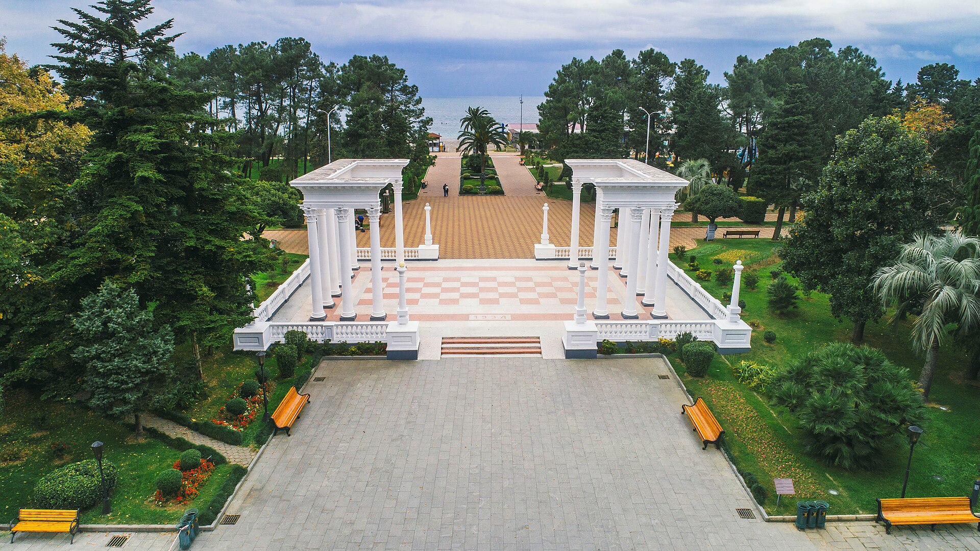 White colonnades opening toward palm trees and the Black Sea along Batumi Boulevard