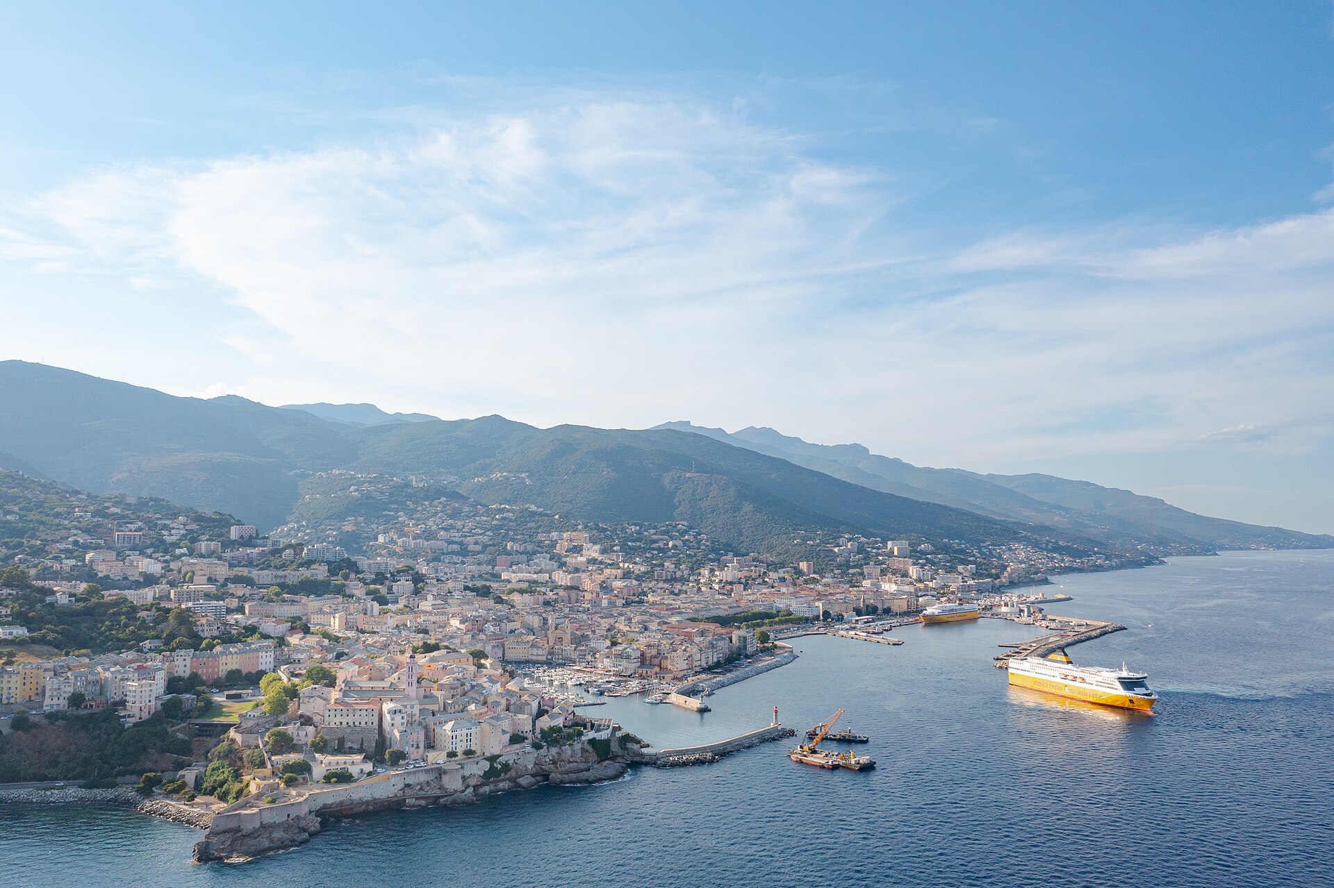 Aerial view of Bastia's commercial and old harbors, city, citadel and ferries on Corsica's northeast coast