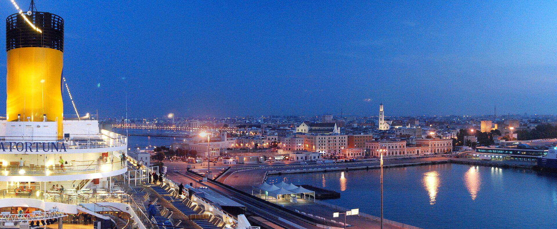 Costa Fortuna cruise ship and the harbor of Bari at twilight