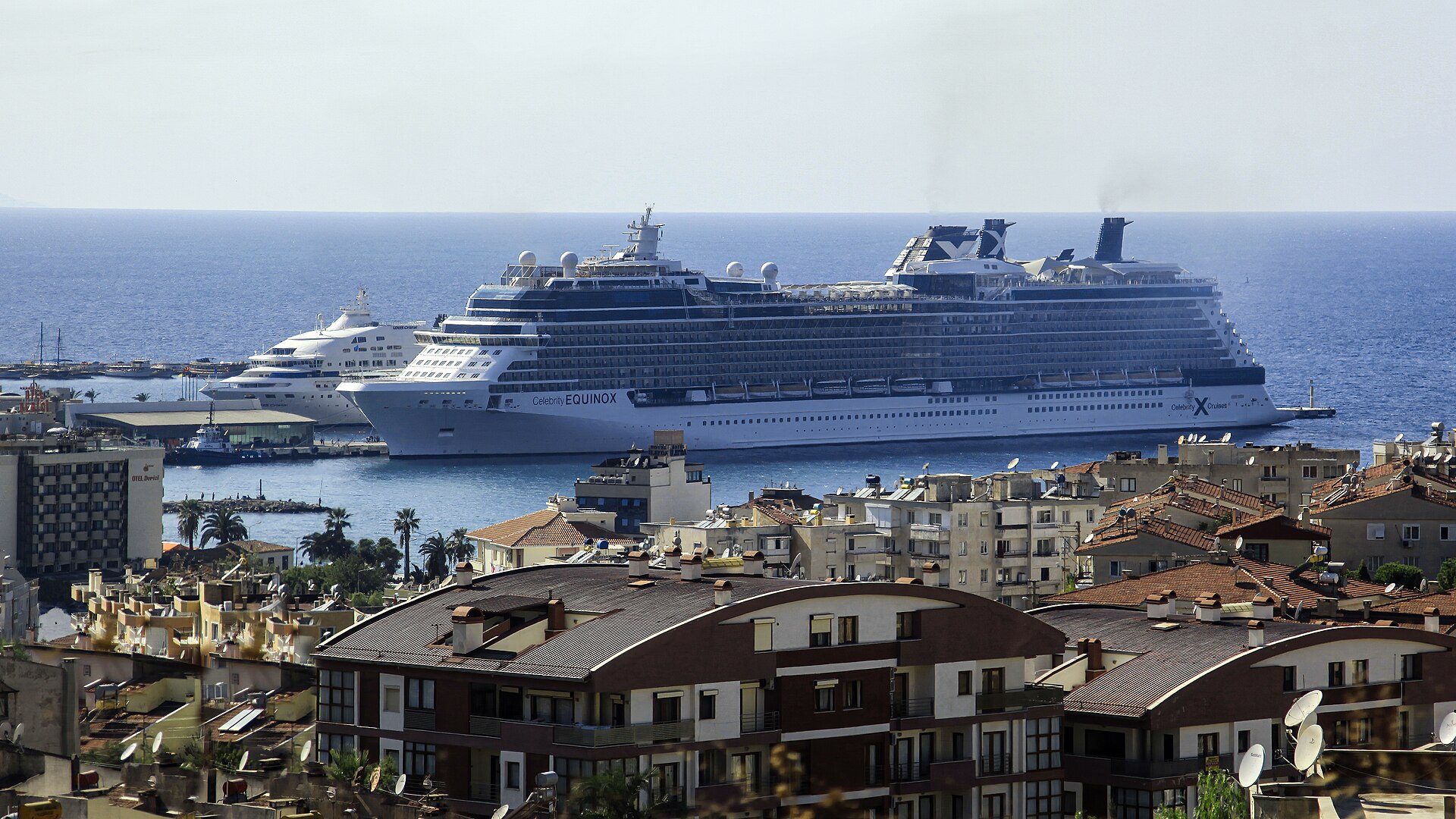 Cruise ships berthed at Kuşadası Cruise Port beyond the red-roofed Aegean waterfront