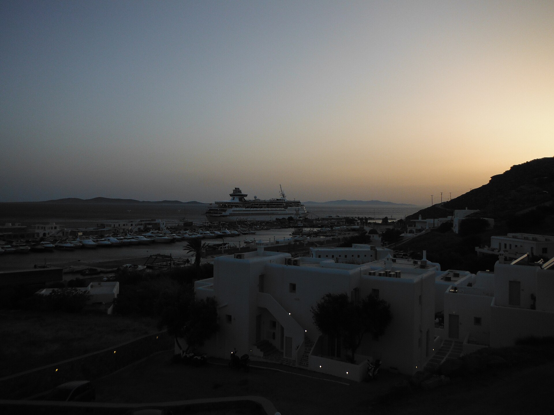 Tourlos New Port on Mykonos with passenger ships and white hillside buildings above the harbor
