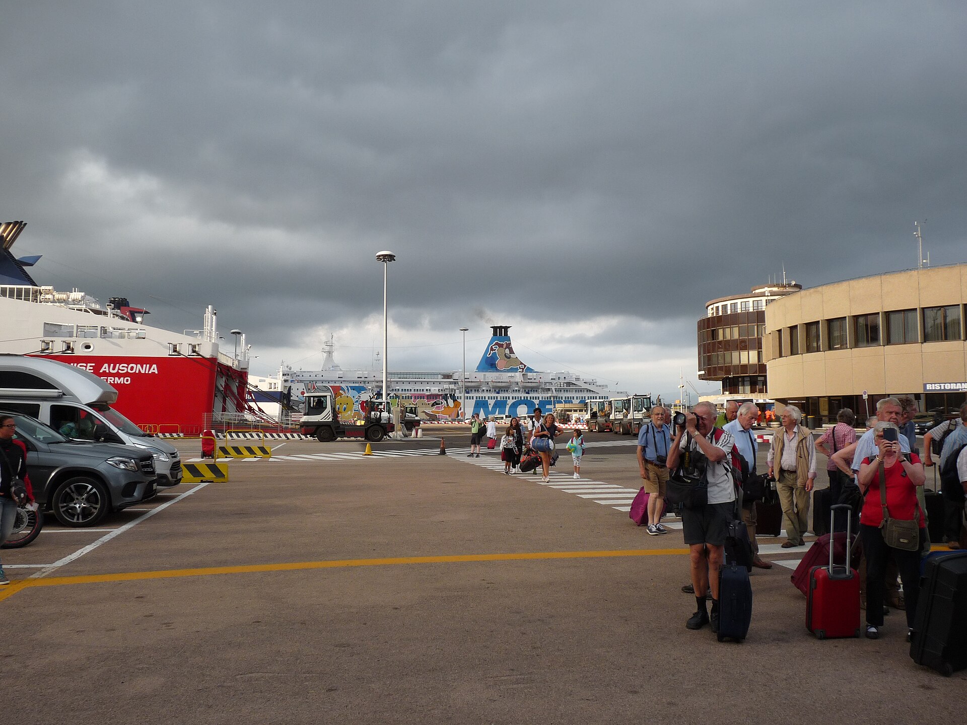 Passengers and vehicles beside ships at Olbia's Isola Bianca harbor in northeast Sardinia