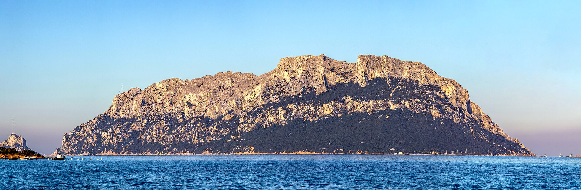 The limestone and granite mass of Tavolara rising from the blue sea off Olbia in northeast Sardinia